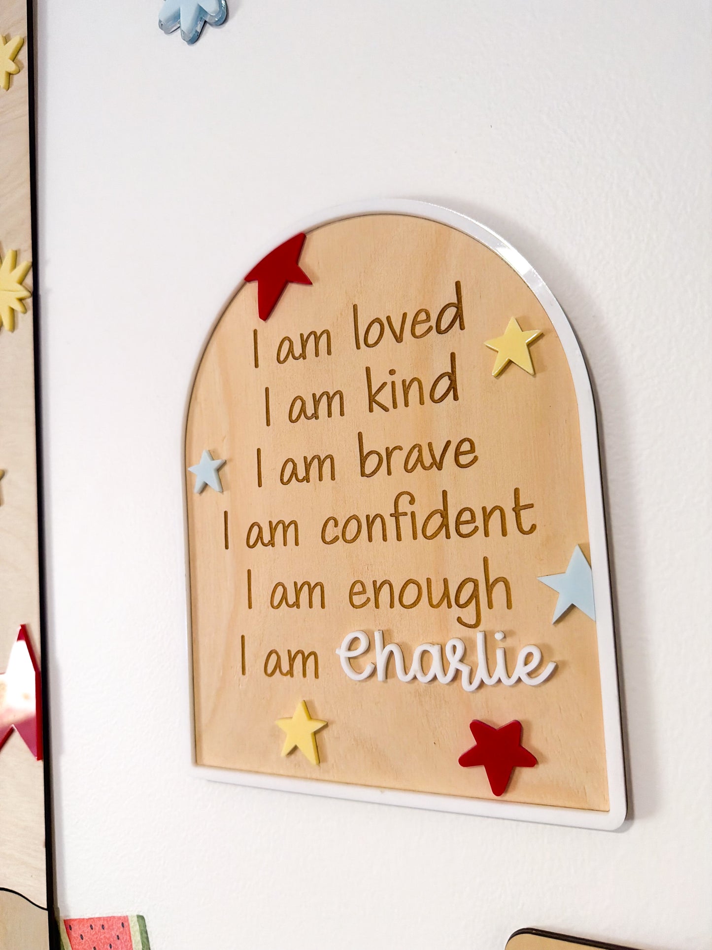 Wooden plaque with motivational phrases and personalized name on a white background