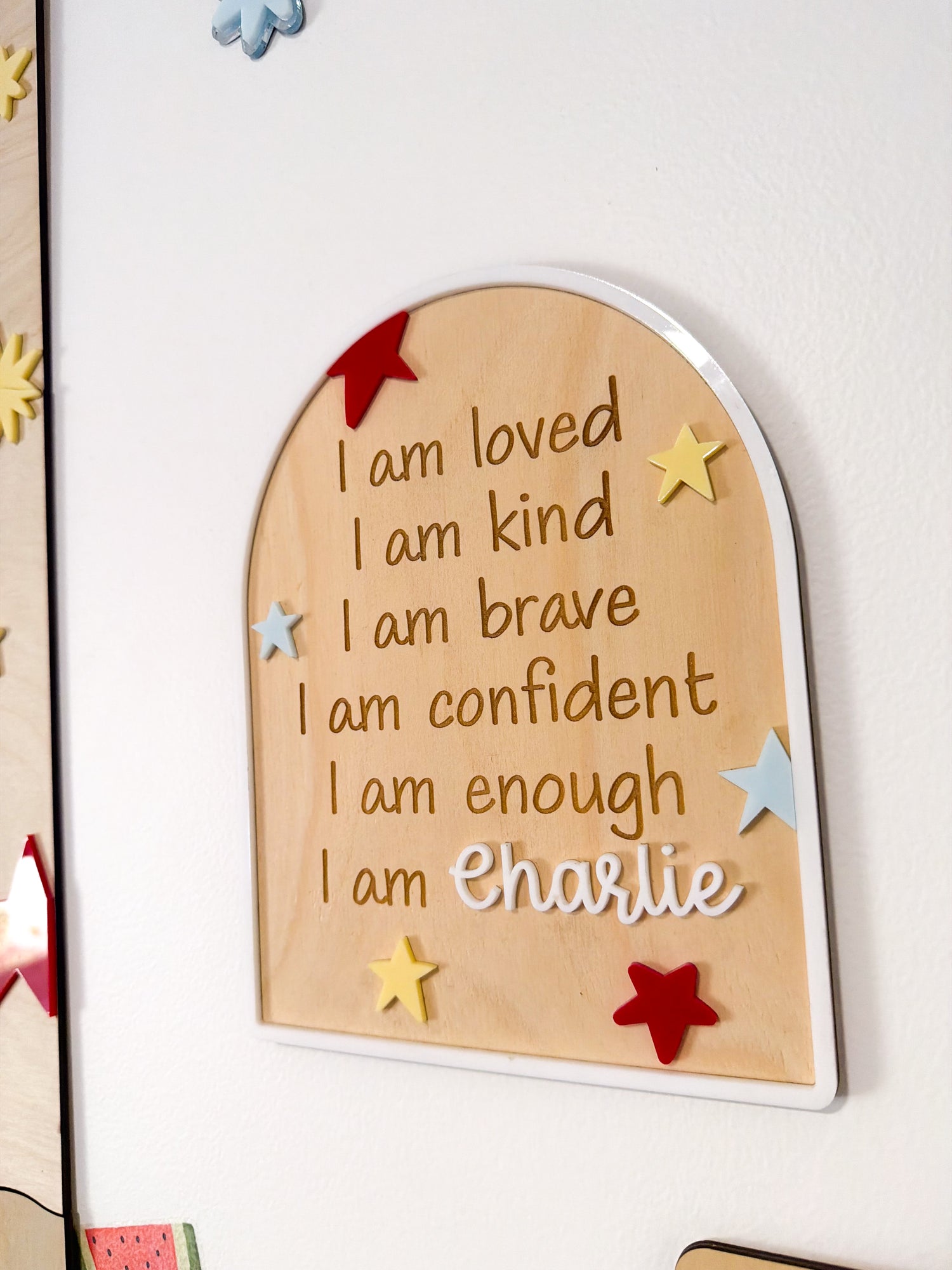 Wooden plaque with motivational phrases and personalized name on a white background