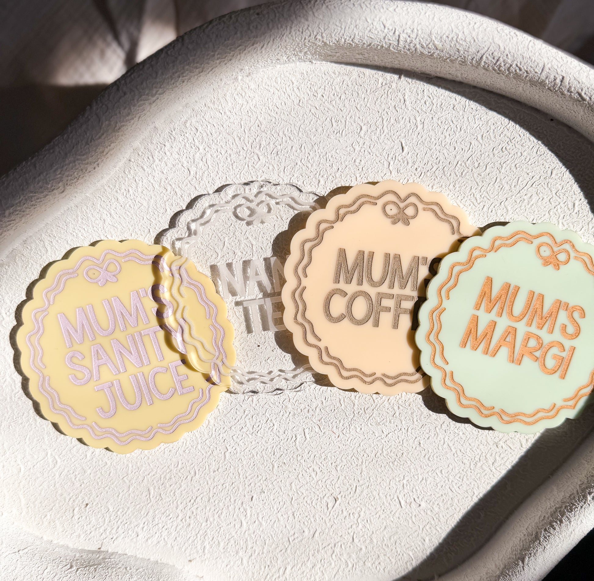 Four round labels with text on a textured surface