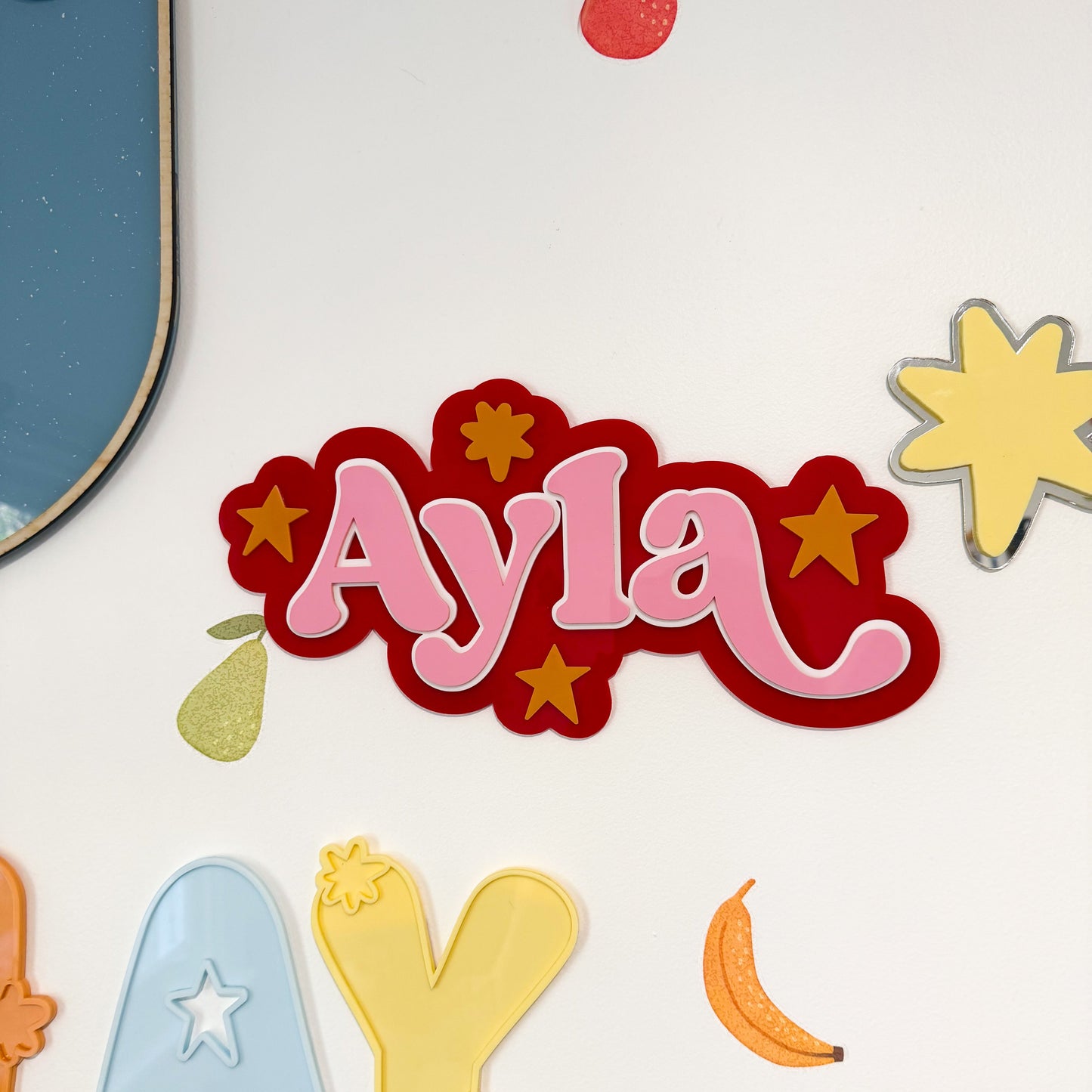 Colorful name 'Ayla' with decorative elements on a white background