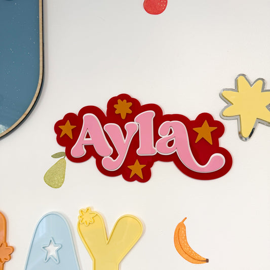 Colorful name 'Ayla' with decorative elements on a white background